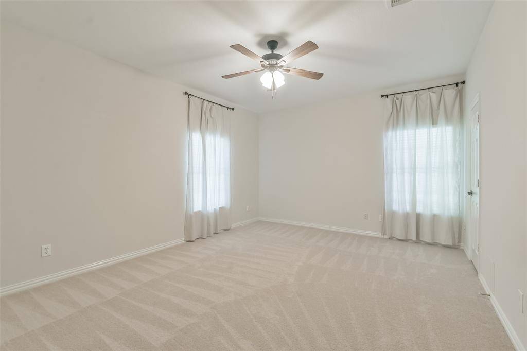 The bath has tile floors, two vanities/sinks with drawer pulls and cultured marble counters, contemporary light fixtures, and a tub/shower combo.