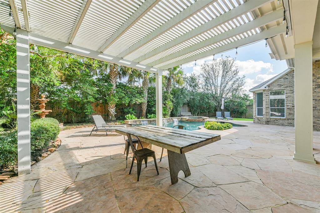 Plenty of room under the covered back patio pergola.  This space is so beautifully shaded with lush landscaping.