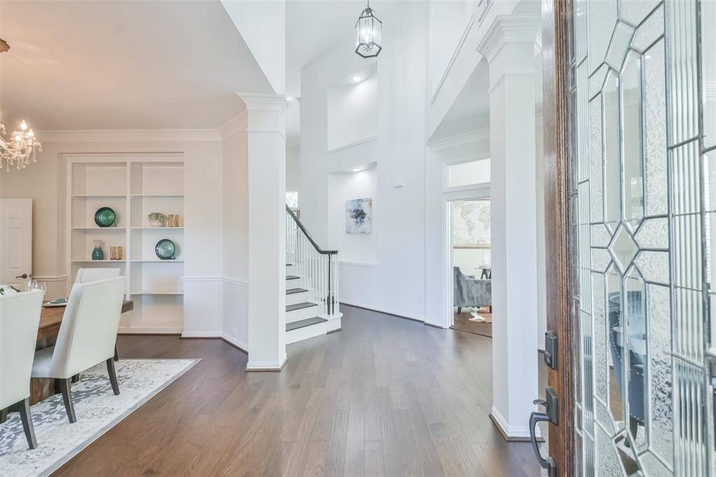 Throughout the home are sophisticated touches such as wood floors, built-in bookcases, beautiful light fixtures, neutral paint, crown molding, high ceilings, ample storage, windows and closets galore, art niches and columns.