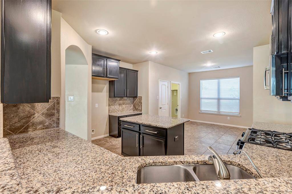 Great view to the huge kitchen from your breakfast bar. Notice the DuPure clean drinking water system/filter installed at kitchen sink.
