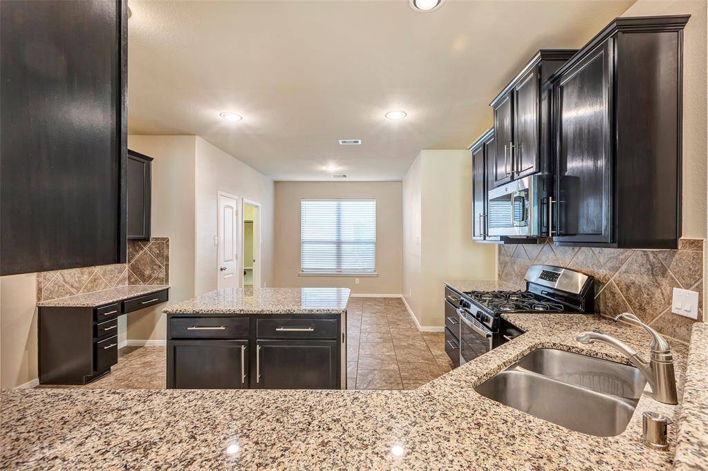 Sleek granite and 42" refinished cabinets are also featured in this kitchen.