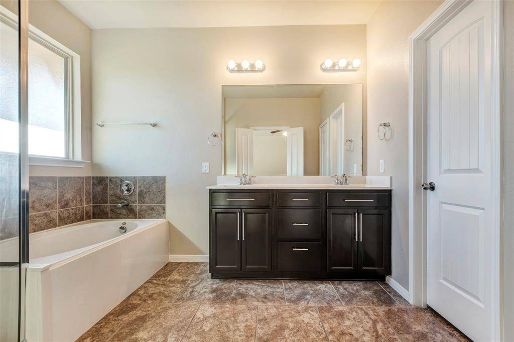 Separate shower and soaking tub in the primary bath.