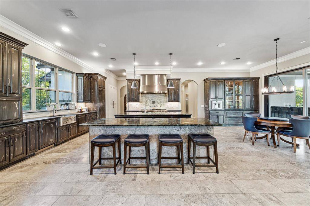 Every chef's dream kitchen offering two dishwashers for added convenience, and two expansive islands in the kitchen for ultimate functionality. The kitchen also boasts a built-in coffee maker, perfect for starting your day in style.