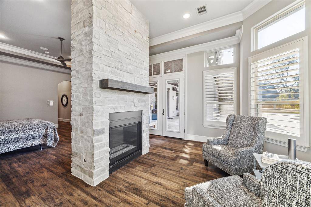 The primary sitting area offers the cozy fireplace but also the perfect backdrop view.