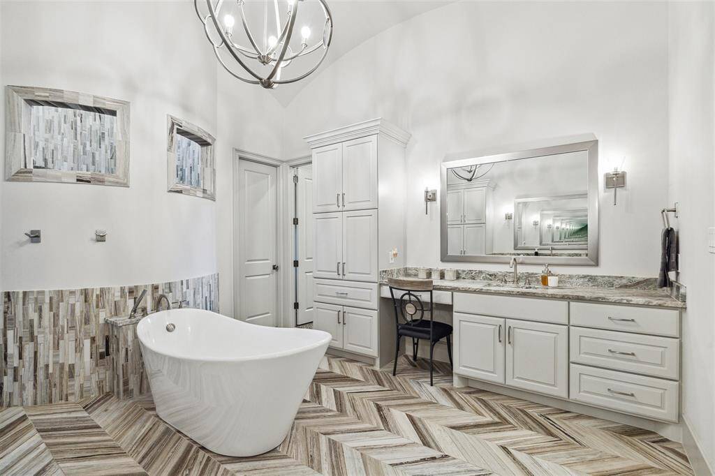The bathroom features two separate vanities, providing ample space for both partners to prepare for the day ahead with ease and convenience.