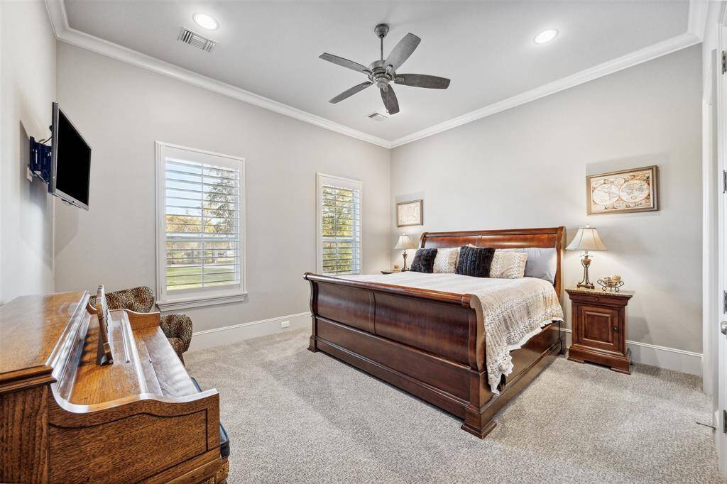 A secondary bedroom on the first floor offers a dedicated private bath, spacious closet and a beautiful view of the front of the property.