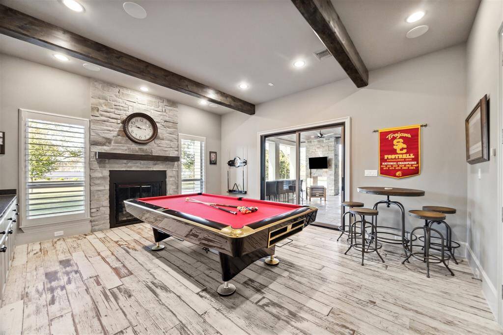 Step into the ultimate entertainment space in this exceptional home - the game room located on the first floor.The game room features easy access to the outdoor kitchen, creating a seamless indoor-outdoor flow for entertaining.