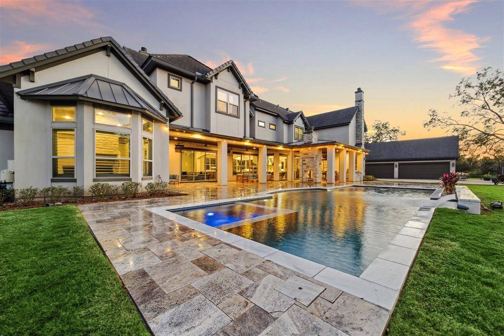 With a perfect blend of comfort, functionality, and style, the large covered patio with seating, fireplace, outdoor kitchen, and pool is a true outdoor sanctuary where you can create lasting memories and enjoy the best of luxury living.