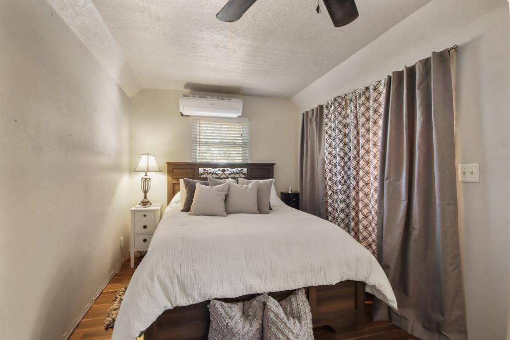 Upstairs bedroom space has a large closet behind the drapes.