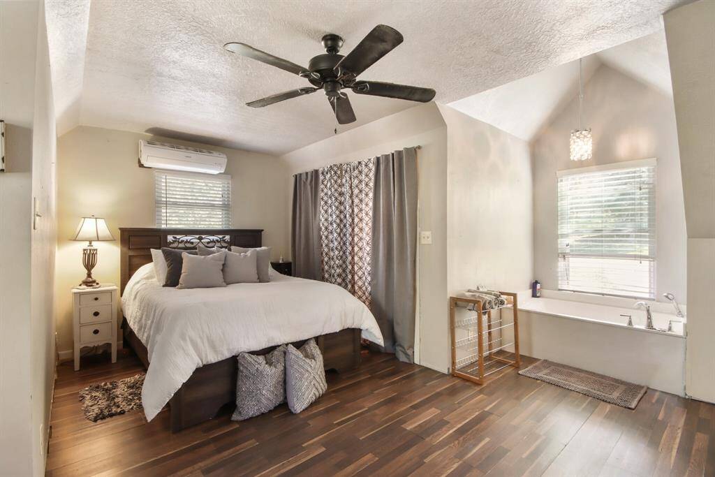 Upstairs bedroom has adjacent bathroom in this open concept floor plan.