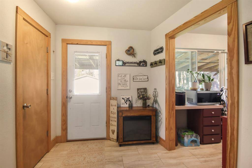 Enter the back door to an extra room that can be used as mud room, or storage. Pantry is also in this room and is open to the laundry room.