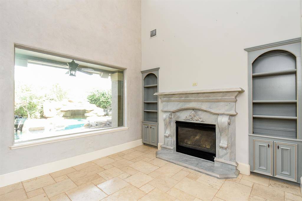 The Formal Living Room is straight from the entry stairs and is gorgeous with stunning views of the back yard and lake!