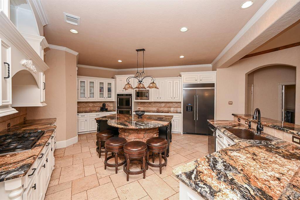 The kitchen was recently updated with white cabinetry to lighten and modernize it and the center island is black!