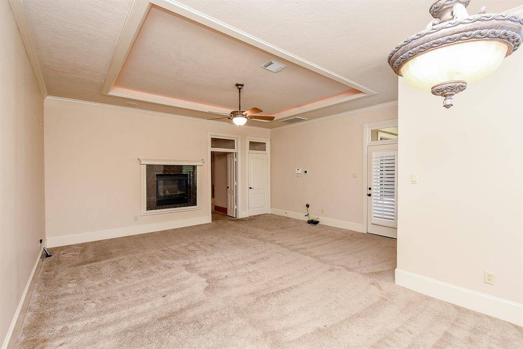 Another view of the Primary Bedroom shows the fireplace in the bedroom as well.