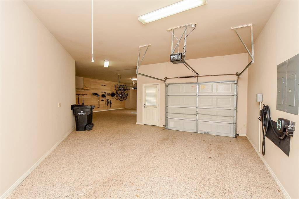 The 3 car garage is very large and also has extra storage, apoxy flooring & a wall of storage in the larger section of the garage.  There is also a full house generator on the side of the home.