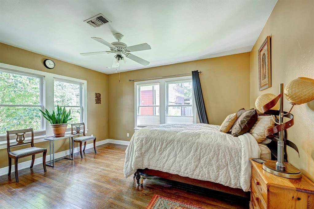Light and bright Primary bedroom with lovely views to patio/garden area, hardwoods, ceiling fam
