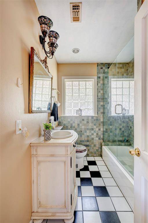 Updated bath with frameless tub/shower and custom vanity/sink