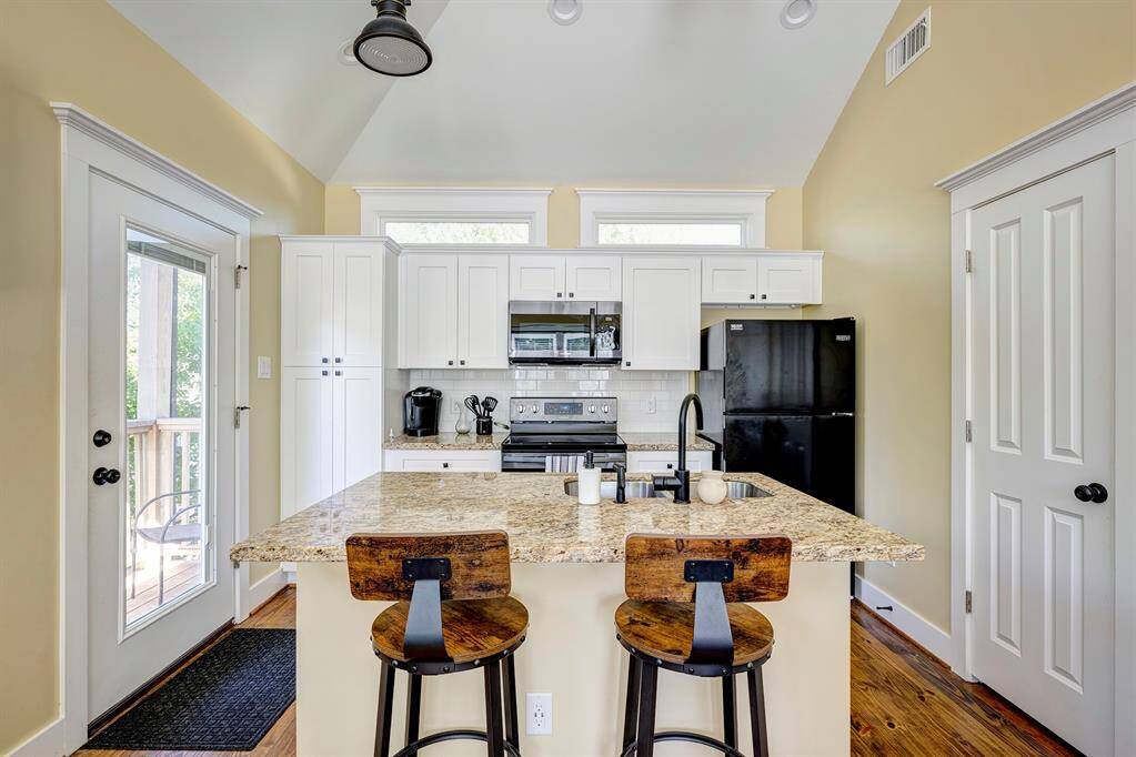 Apt kitchen, well-equipped, opens to living area