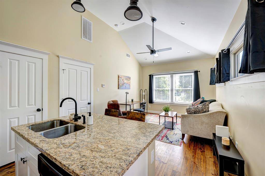 Garage apt kitchen opens to large living area. Large living/entertaining are tastefully decorated and all furnishings remain