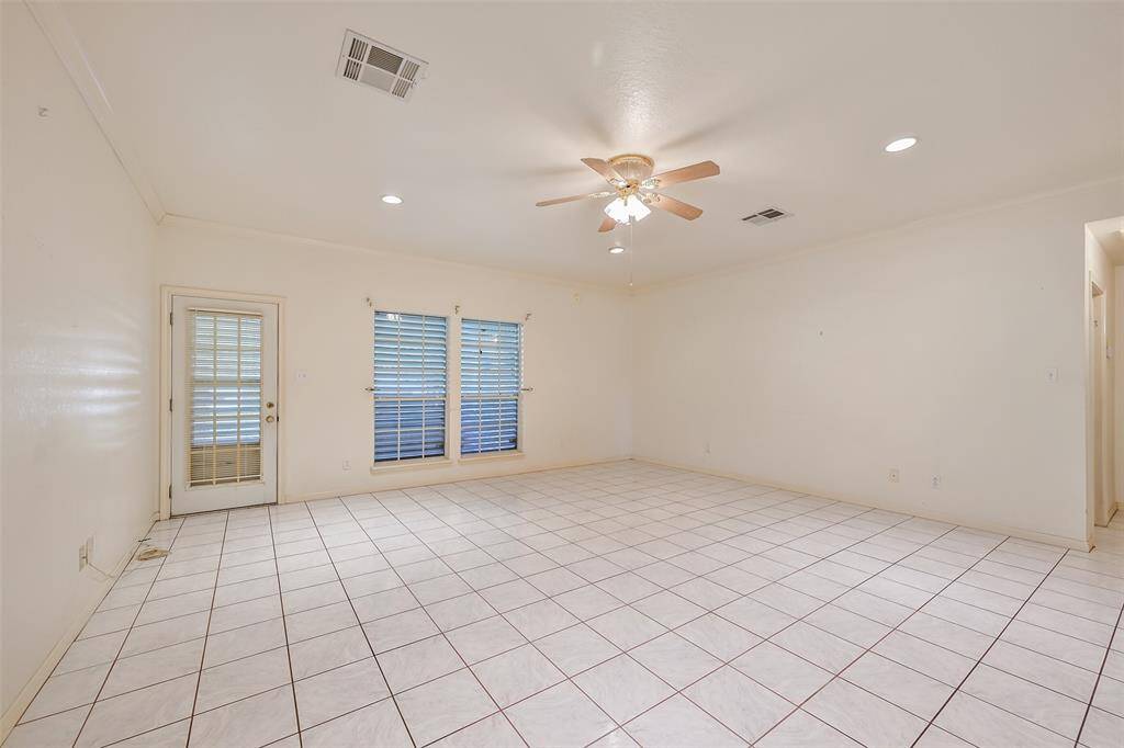 Living room, crown molding and tall ceilings, tile flooring (porcelain per seller).