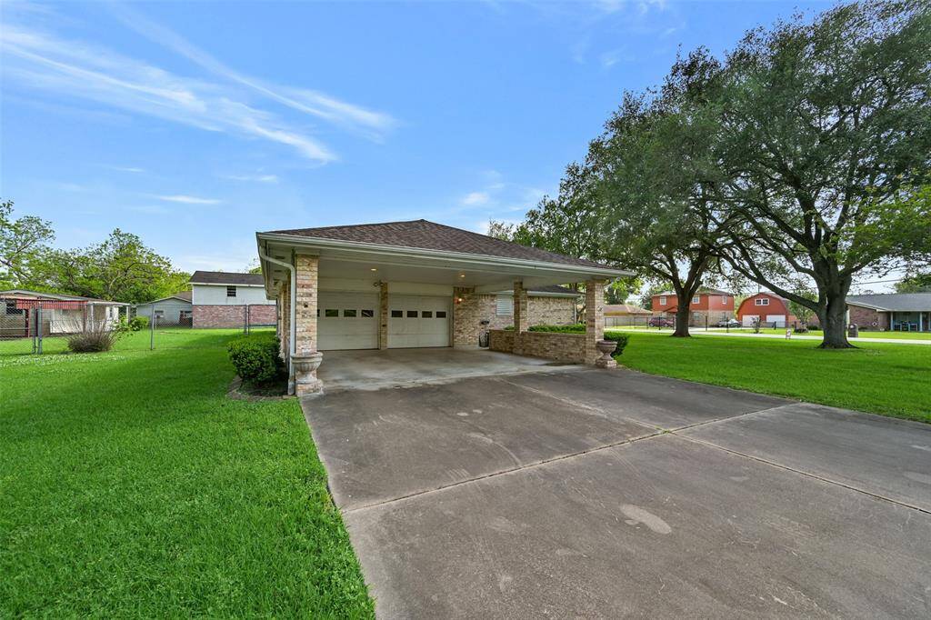 Carport leading to oversized 2 car garage with bathroom