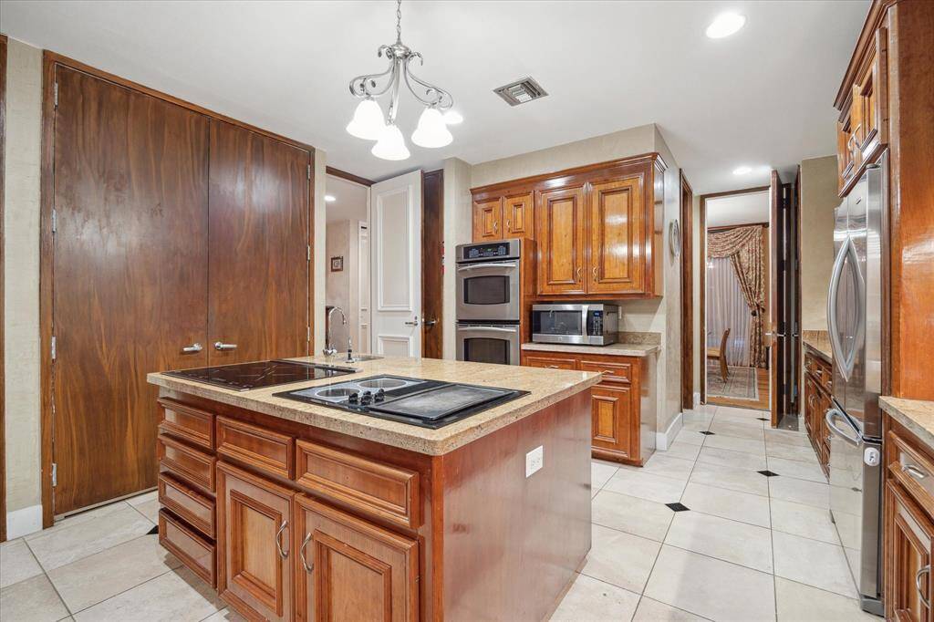 The kitchen features stainless appliance package opens to formal dining room.