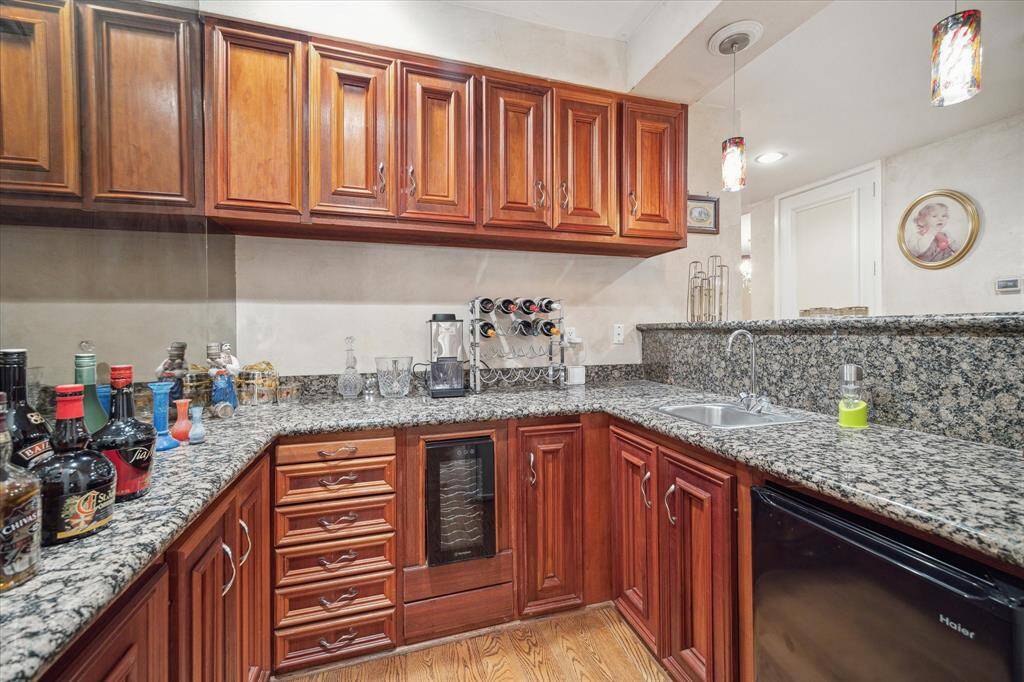 The wet bar with large serving counter and ample storage.