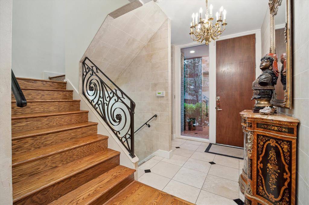 The main entry has a staircase and glass elevator for access to all floors and the private garage.