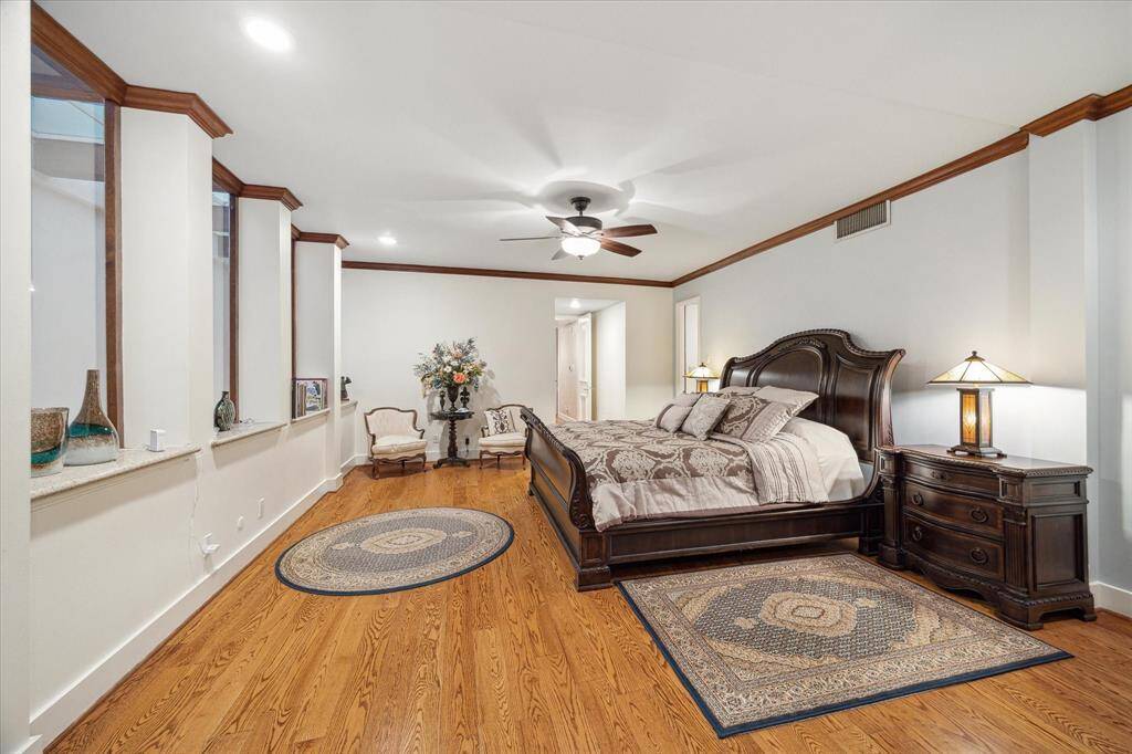 Spacious primary suite featuring elegant hardwood floors.