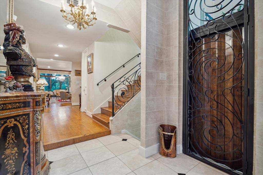 The main entry has a staircase and glass elevator for access to all floors and the private garage.