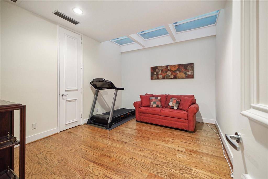 Bright secondary bedroom featuring stunning skylights.