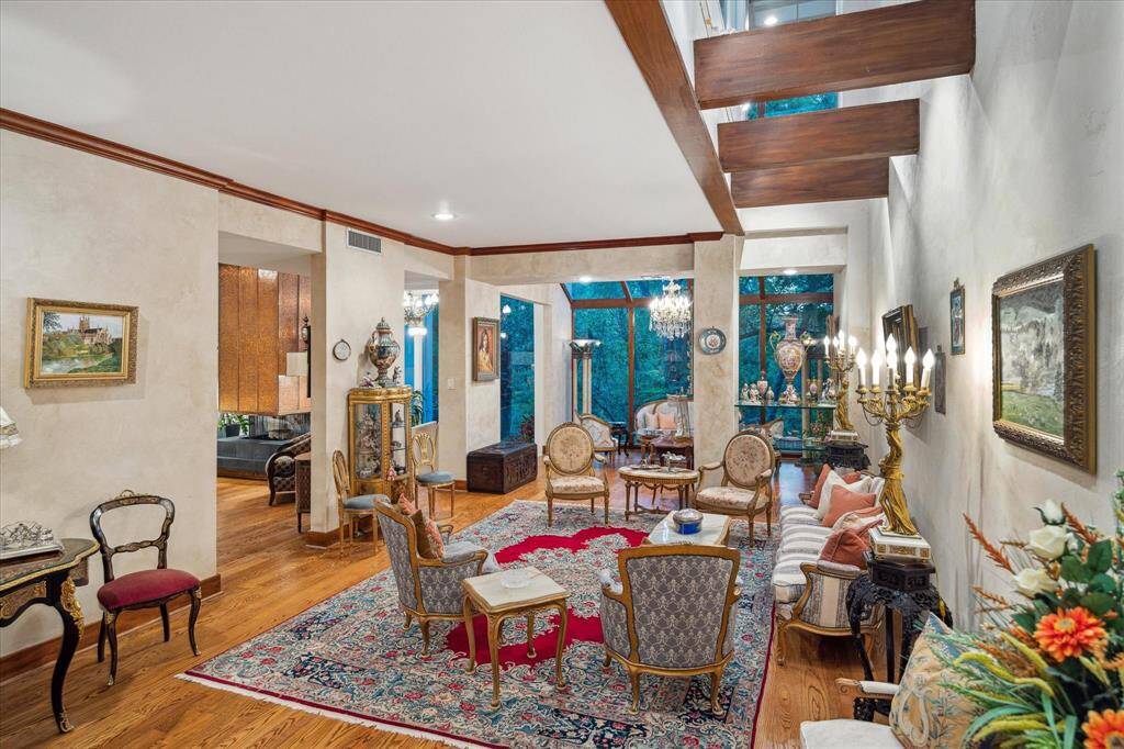 Flooded with natural light, the formal living room features floor-to-ceiling windows.