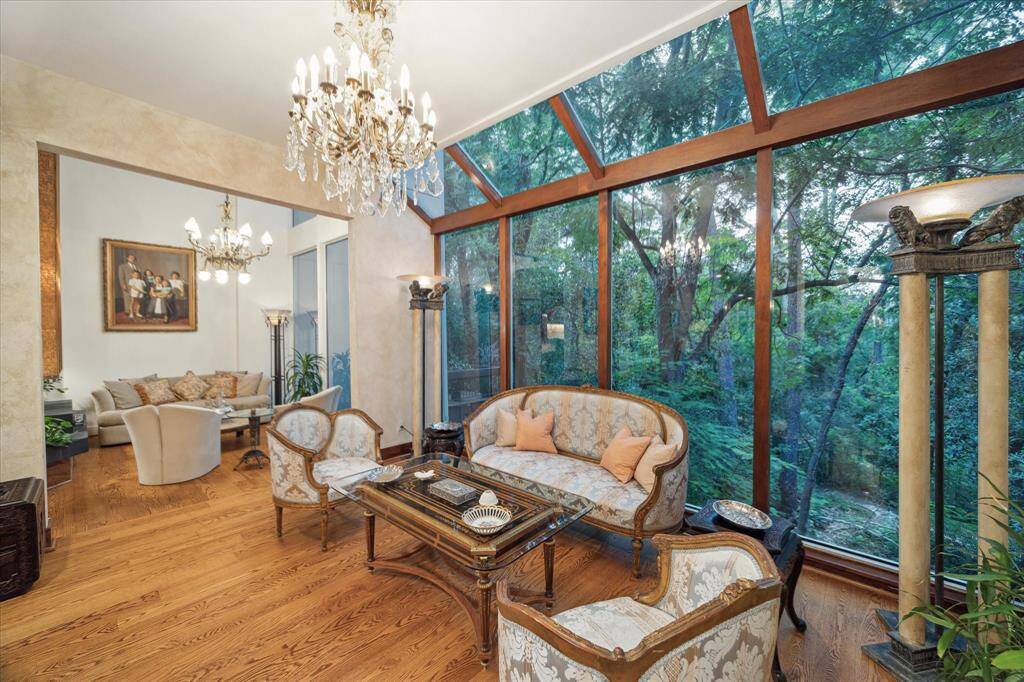 The lovely sunroom with breathtaking views of serene woodland trails.