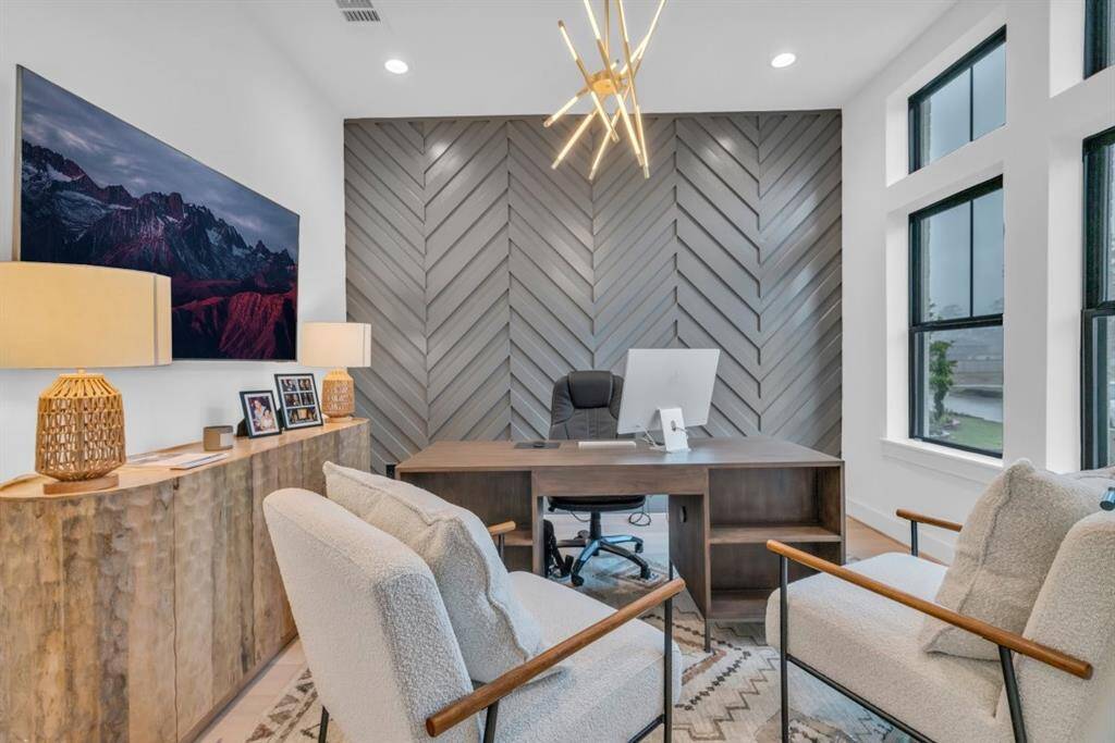 All photos are the model home. The study features a unique accent wall.