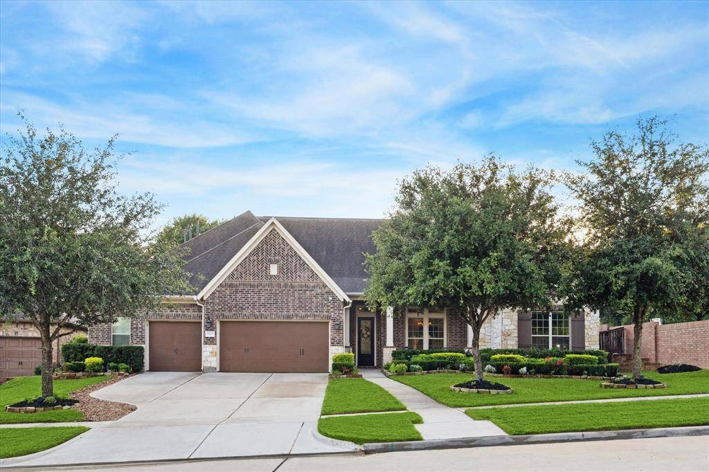 Gorgoeus brick and stone front elevation on this 1.5 story home on a corner lot with no back neighbors!