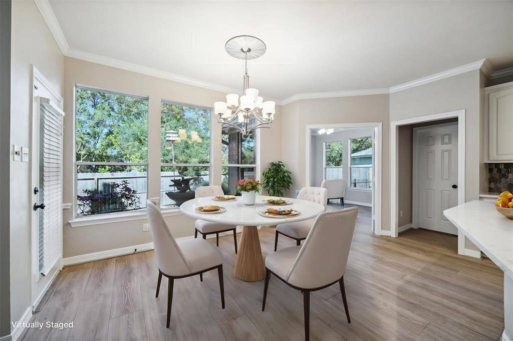 Breakfast room is spacious with view of beautiful back yard and is open to the family room and kitchen.