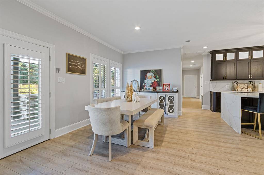 The breakfast area is conveniently situated off the kitchen and overlooks the backyard. Shutters throughout help to bring the natural light in!  Cabinets have been painted a tan color recently.