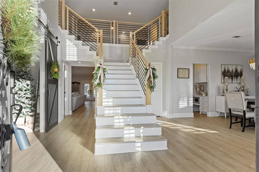 Simply breathtaking!  This stunning staircase with be the perfect place for all the family photos! Beautiful engineered wood floors throughout.