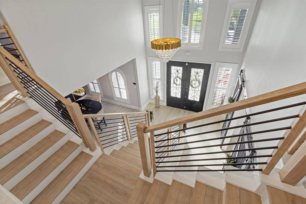 A view from the 2nd floor to the foyer. Gorgeous entry chandelier. Complete with shutters throughout.  This house is light and bright!