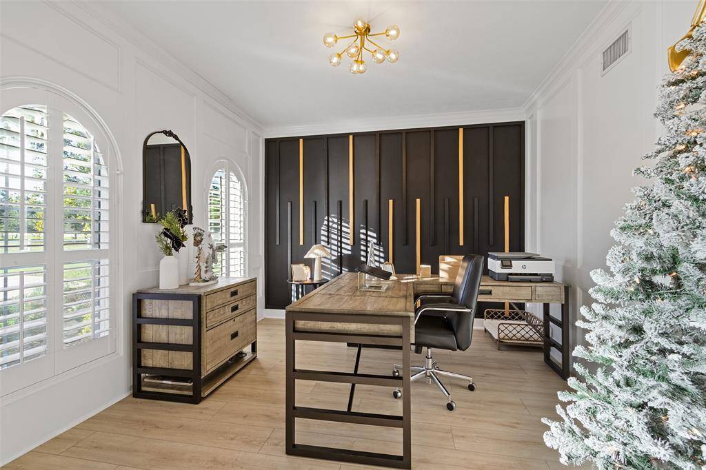 The home office is the perfect place for those that choose to work from home. Darling light fixture.