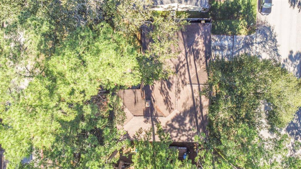 A direct aerial view of 1805 Twila Lane showcases the home’s well-maintained roof and lush tree canopy, providing natural shade and a serene setting. The spacious lot offers privacy and a peaceful retreat in a desirable neighborhood.