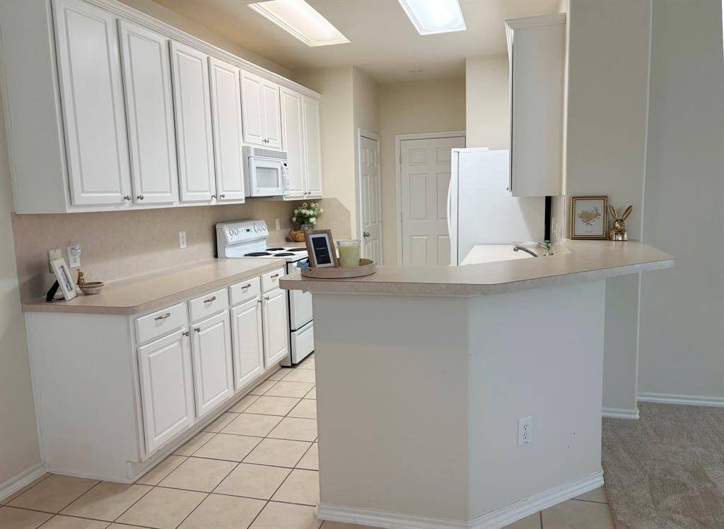 This kitchen has an amazing amount of cabinets for storage.