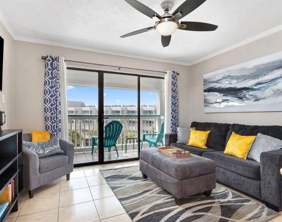 This inviting living area features an open-concept design that flows seamlessly onto the patio, where you can soak in beautiful ocean views.