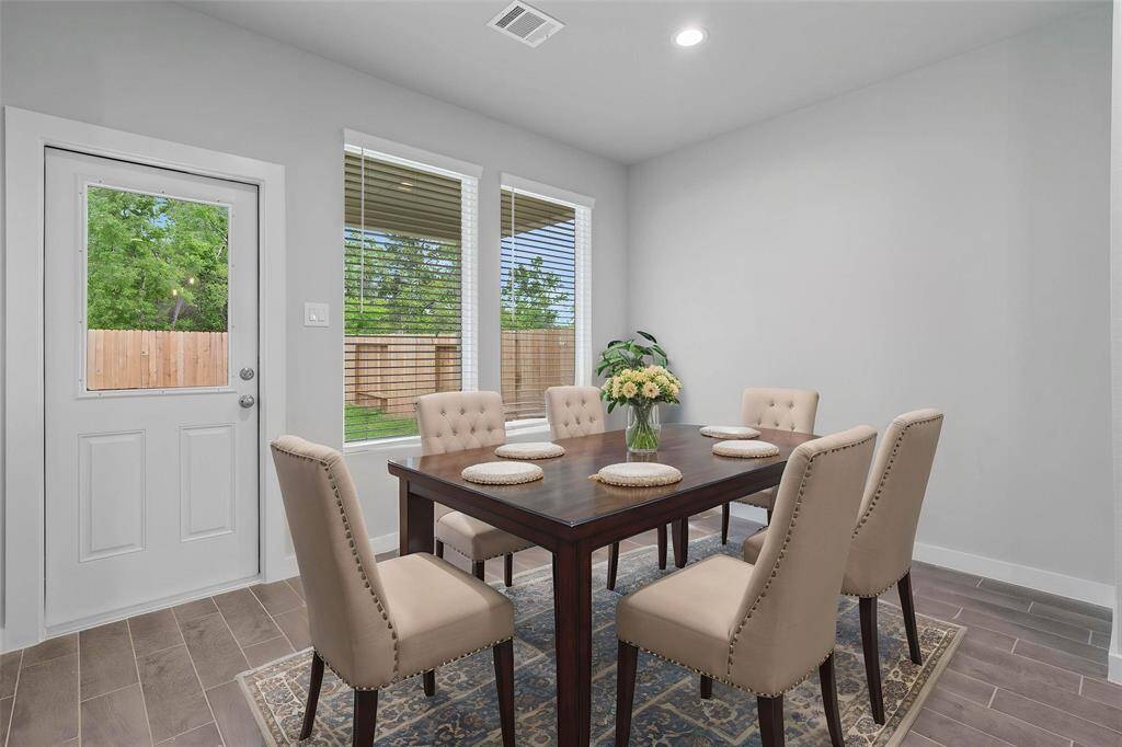 Make memories gathered around the table with your family and friends! This dining room features high ceilings, recessed lighting, large windows, and gorgeous tile flooring!