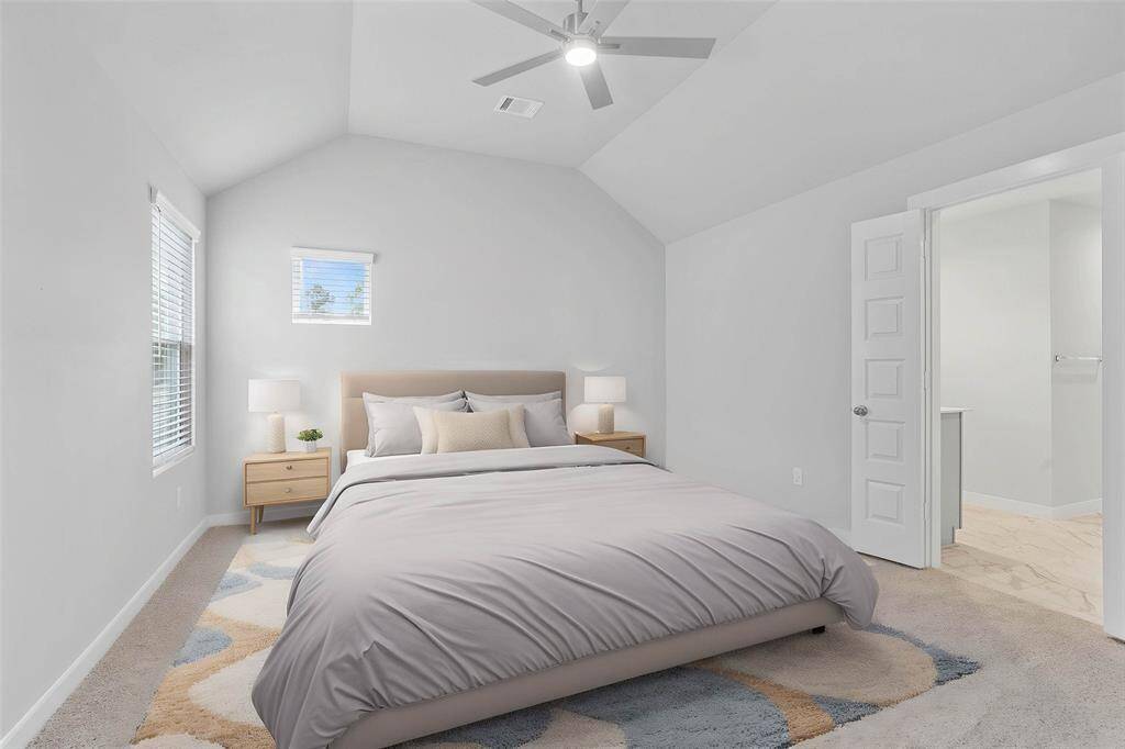 What a wonderful place to come home to, this stunning primary suite greets you with plush carpet, warm custom paint, high ceiling with ceiling fan, and lovely windows!