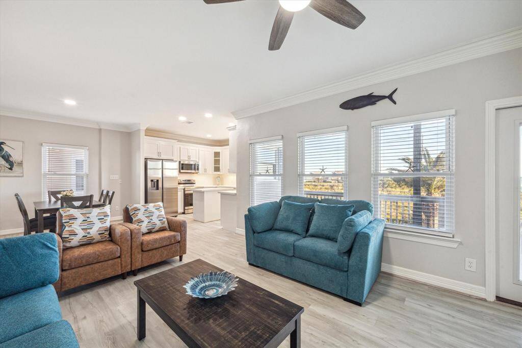 Open to the beautifully remodeled kitchen, with crown molding, luxury vinyl plank flooring and beautiful fresh paint.