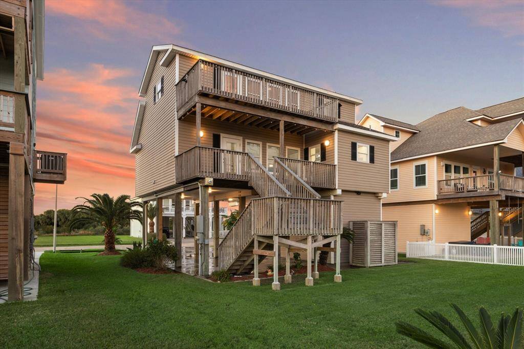 View of the rear of the home and large back yard.