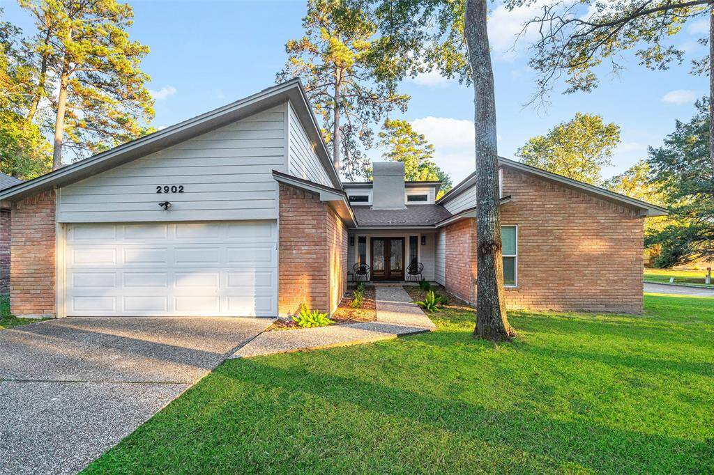 Charming single-story brick home with a two-car garage and well-maintained front yard. Features a welcoming front entrance with large windows and mature trees, offering great curb appeal in a serene neighborhood.