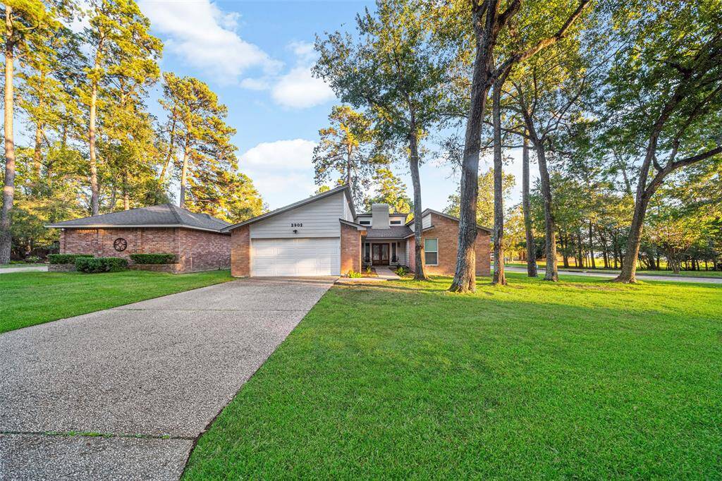 Charming brick home with a spacious front yard and mature trees, featuring a two-car garage and a long driveway. Ideal for those seeking a serene, suburban setting.