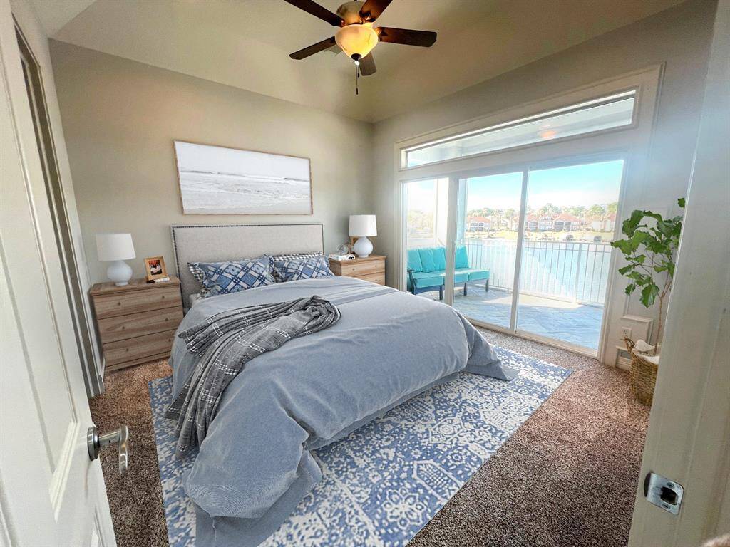 Large Primary Bedroom with Great View of the Lake. NEW carpet & sliding door that opens to your screened in patio. virtual staged